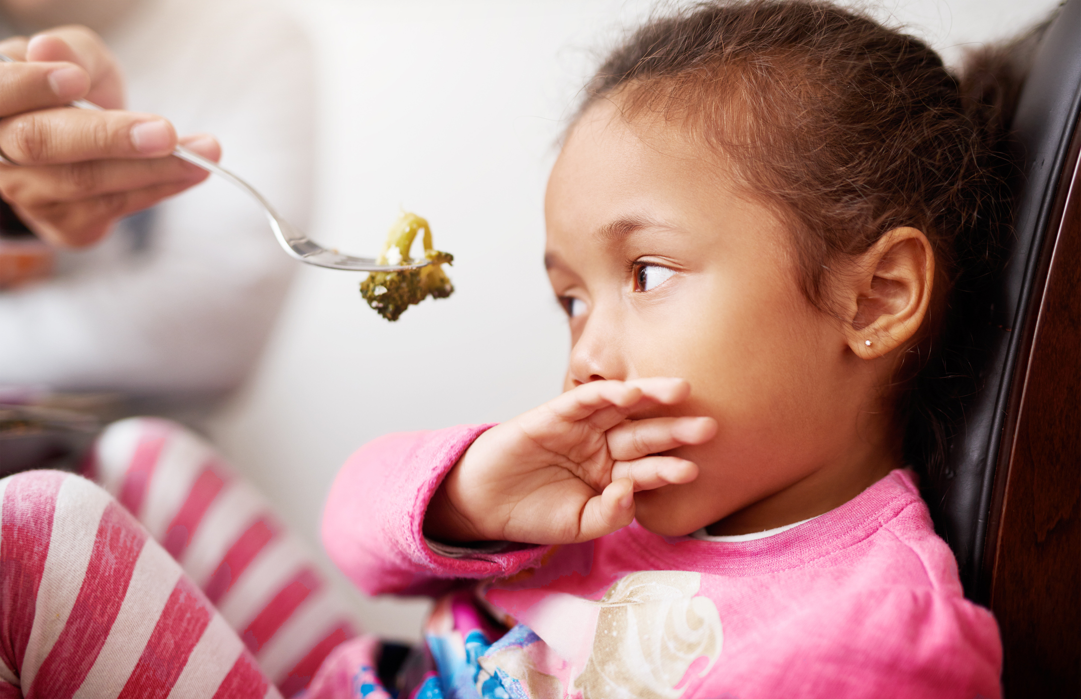 Child trying new food for the first time.