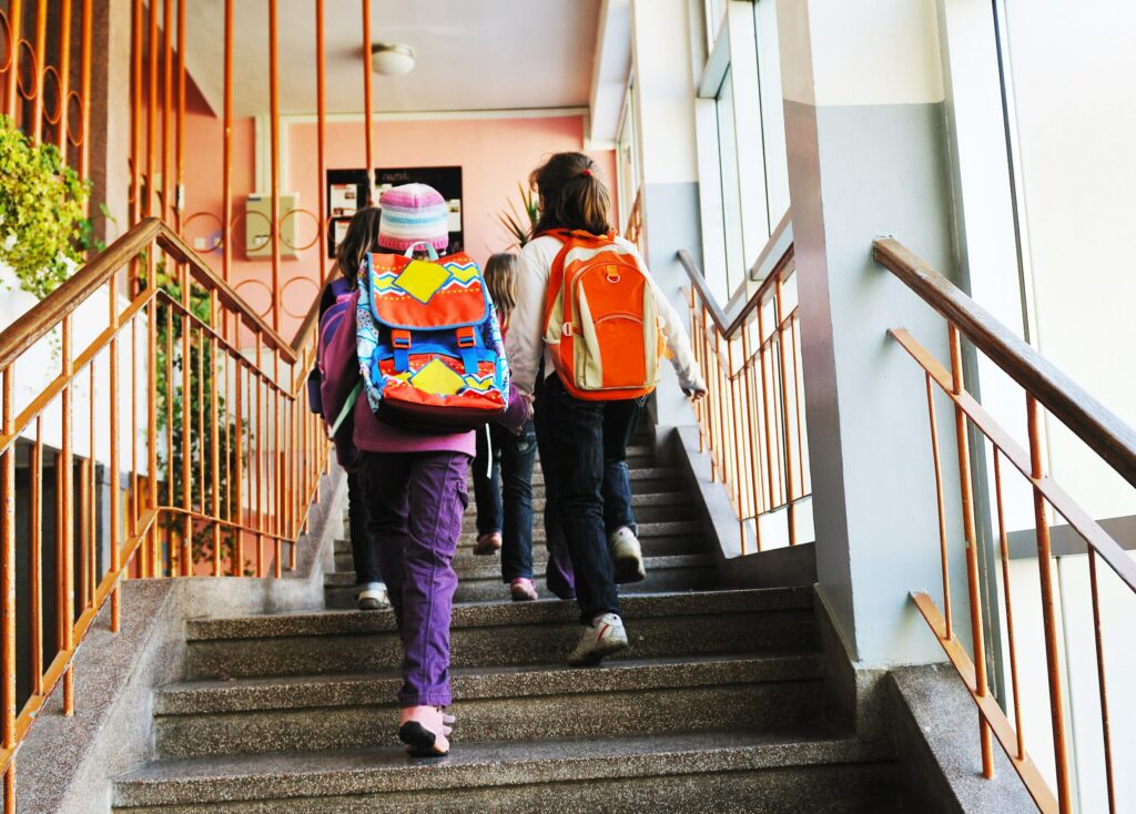 Children attending school with backpacks