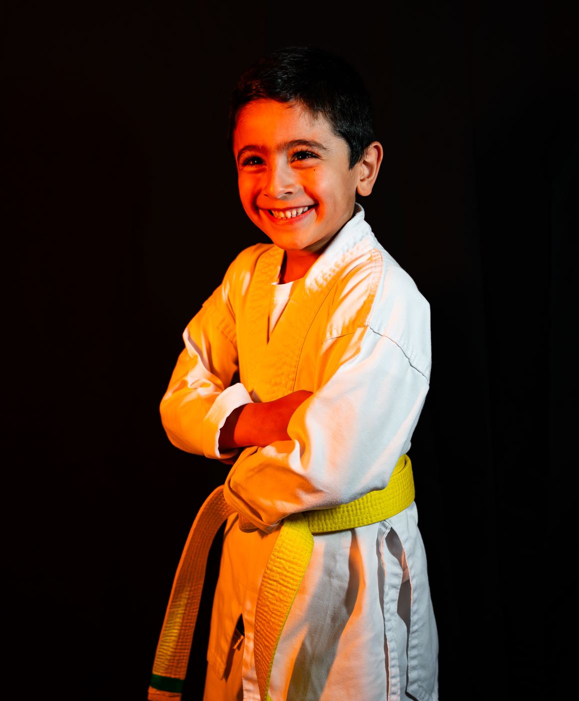 A smiling boy with a yellow belt at The Warrior Academy