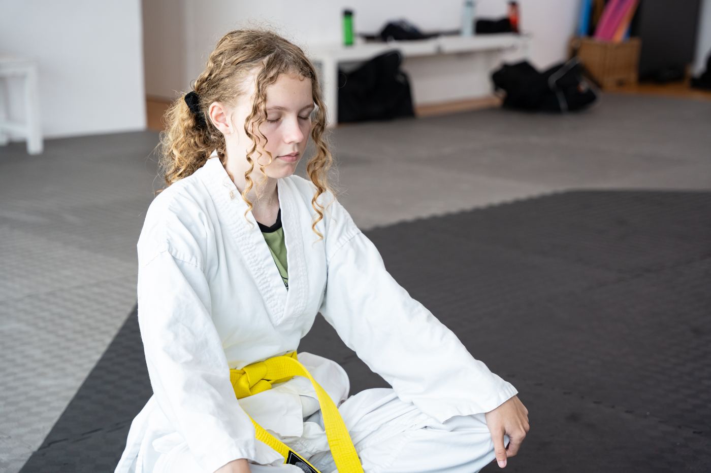 A girl meditates calmly on the mat