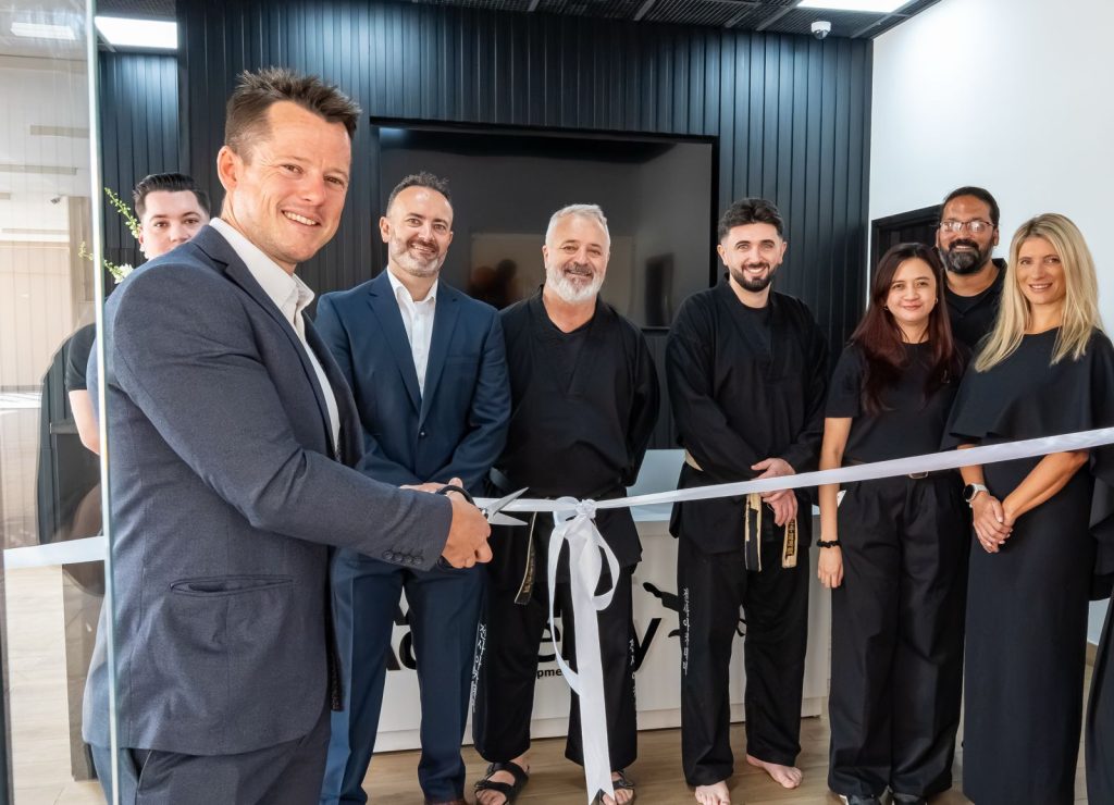 Sebastian Bates and The Warrior Academy team cutting the ribbon at a new academy